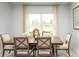 Bright dining room featuring a wood table, six chairs, and a large window with lake views at 4649 Spire Run, Lakewood Ranch, FL 34211
