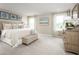 Bright, spacious main bedroom featuring elegant furnishings and soft, neutral colors at 4649 Spire Run, Lakewood Ranch, FL 34211