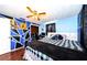 Well-decorated bedroom with a black and white theme, hardwood floors, and stylish wall art at 4938 Fruitwood Loop, Holiday, FL 34690