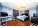 Cozy bedroom with hardwood floors, a ceiling fan, and neutral walls creating a relaxing space at 4938 Fruitwood Loop, Holiday, FL 34690