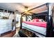 This cozy bedroom features a canopy bed, modern art and access to other rooms via sliding glass door at 4938 Fruitwood Loop, Holiday, FL 34690