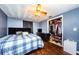 Comfortable bedroom with hardwood floors, a ceiling fan, and a closet for ample storage at 4938 Fruitwood Loop, Holiday, FL 34690