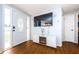 Inviting entryway with wood-look flooring, decorative door, a console with fireplace, and a large TV at 4938 Fruitwood Loop, Holiday, FL 34690