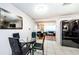 Eat-in kitchen area with modern appliances and a table, leading to a cozy living room with comfortable seating at 4938 Fruitwood Loop, Holiday, FL 34690