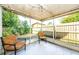 View of the home's patio and backyard with screened in windows, string lights, and chairs at 4938 Fruitwood Loop, Holiday, FL 34690