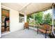 View of the home's patio with screened in windows, string lights, and outdoor chairs at 4938 Fruitwood Loop, Holiday, FL 34690