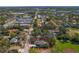 Aerial view: a home with a manicured yard, street access, and a nearby baseball field in a residential area at 513 Meres Blvd, Tarpon Springs, FL 34689