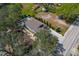 Aerial view of a single-Gathering home on a spacious lot near a baseball field with mature trees and a well-maintained yard at 513 Meres Blvd, Tarpon Springs, FL 34689