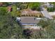 An aerial view of a charming home with a well-maintained lawn and mature trees providing ample shade at 513 Meres Blvd, Tarpon Springs, FL 34689