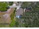 Aerial view features a single-Gathering home with mature landscaping, a long driveway, and proximity to neighborhood streets at 513 Meres Blvd, Tarpon Springs, FL 34689
