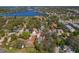 The view shows a home's setting near a baseball field with glimpses of a lake beyond the surrounding neighborhood at 513 Meres Blvd, Tarpon Springs, FL 34689