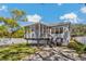 Exterior view of a home with a screened porch and a well-maintained backyard at 513 Meres Blvd, Tarpon Springs, FL 34689