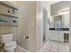 Well-lit bathroom featuring a toilet, vanity, and walk-in shower at 513 Meres Blvd, Tarpon Springs, FL 34689