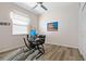 Clean, neutral bedroom with wood-look flooring, fan, desk and large window for ample natural light at 513 Meres Blvd, Tarpon Springs, FL 34689