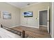 Bright bedroom featuring wood floors, large TV, and a beach-themed art piece at 513 Meres Blvd, Tarpon Springs, FL 34689