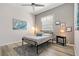 Bright bedroom featuring a comfortable bed, accent lighting, and stylish decor at 513 Meres Blvd, Tarpon Springs, FL 34689
