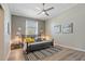 Comfortable bedroom with ceiling fan, beach-themed decor and wood-look floors at 513 Meres Blvd, Tarpon Springs, FL 34689