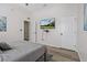 Comfortable bedroom with neutral decor, a mounted TV, and ample closet space at 513 Meres Blvd, Tarpon Springs, FL 34689