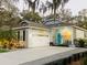 Attractive single story home at dusk featuring a front porch and a two-car garage at 513 Meres Blvd, Tarpon Springs, FL 34689