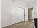 Hallway featuring wood-look flooring and a closet with sliding doors at 513 Meres Blvd, Tarpon Springs, FL 34689