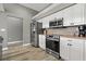 Well-equipped kitchen with stainless steel appliances and bright white cabinetry at 513 Meres Blvd, Tarpon Springs, FL 34689