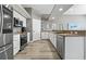 Well-lit kitchen featuring white cabinets, stainless steel appliances, and ample counter space at 513 Meres Blvd, Tarpon Springs, FL 34689