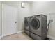 Laundry room features a side-by-side washer and dryer and tile flooring at 513 Meres Blvd, Tarpon Springs, FL 34689