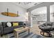 Open living room with surfboard decor, comfortable seating, and views of the kitchen at 513 Meres Blvd, Tarpon Springs, FL 34689