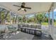 Inviting screened porch with ample seating and a view of the outdoors at 513 Meres Blvd, Tarpon Springs, FL 34689
