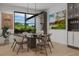 Elegant dining room featuring a modern table, stylish chairs, a wine rack, and a large window with a scenic view at 5413 Deltona Blvd, Spring Hill, FL 34606