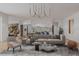 Bright living room showcasing modern lighting, chic furniture, an open layout, and access to the kitchen at 5413 Deltona Blvd, Spring Hill, FL 34606