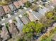 An aerial view of a neighborhood with mature trees and well-maintained lawns at 5492 Legend Hills Ln, Spring Hill, FL 34609
