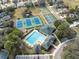 Wide aerial of community pool, tennis courts, playground and parking lot at 5492 Legend Hills Ln, Spring Hill, FL 34609