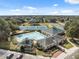 Sprawling community with pool, tennis courts, clubhouse and lush green trees at 5492 Legend Hills Ln, Spring Hill, FL 34609