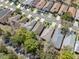 Aerial perspective of a community showcasing homes lining a quiet street, featuring mature trees and green spaces at 5492 Legend Hills Ln, Spring Hill, FL 34609