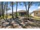 Scenic backyard featuring mature trees and an exterior view of the property at 5492 Legend Hills Ln, Spring Hill, FL 34609