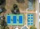 Birds-eye view displaying a basketball court, tennis courts, and neat landscaping at 5492 Legend Hills Ln, Spring Hill, FL 34609