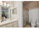 Bright bathroom featuring a sliding glass shower door, tile flooring, and a white toilet at 5492 Legend Hills Ln, Spring Hill, FL 34609