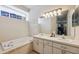 Bright bathroom features dual sinks, a soaking tub, and ample counter space at 5492 Legend Hills Ln, Spring Hill, FL 34609