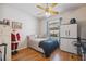 Comfortable bedroom with a ceiling fan, hardwood floors, and a window view at 5492 Legend Hills Ln, Spring Hill, FL 34609
