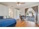 Cozy bedroom with hardwood floors and sliding glass doors that lead to a patio at 5492 Legend Hills Ln, Spring Hill, FL 34609