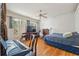 Comfortable bedroom with hardwood floors, a ceiling fan, and large windows for natural light at 5492 Legend Hills Ln, Spring Hill, FL 34609