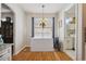 Dining area with hardwood floors, chandelier, and view into laundry room at 5492 Legend Hills Ln, Spring Hill, FL 34609