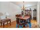 Elegant dining room features hardwood floors, a chandelier, and a wooden table with seating for four at 5492 Legend Hills Ln, Spring Hill, FL 34609