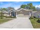 Charming one-story home with a well-manicured lawn and attached two-car garage at 5492 Legend Hills Ln, Spring Hill, FL 34609