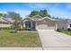 Charming one-story home with a well-manicured lawn and attached two-car garage at 5492 Legend Hills Ln, Spring Hill, FL 34609