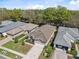 Inviting single-Gathering home with manicured lawn, mature trees, and a spacious two-car garage at 5492 Legend Hills Ln, Spring Hill, FL 34609