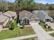 Well-maintained single-Gathering home with a spacious driveway, beautiful landscaping, and attached garage at 5492 Legend Hills Ln, Spring Hill, FL 34609