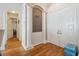 Spacious foyer with wood floors, archway, and white columns framing a gray accent wall at 5492 Legend Hills Ln, Spring Hill, FL 34609