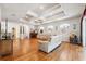 Large living area with hardwood floors, coffered ceiling, and ample space for entertaining at 5492 Legend Hills Ln, Spring Hill, FL 34609